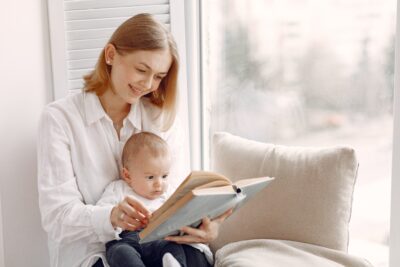 A nurse reading a book to an infant