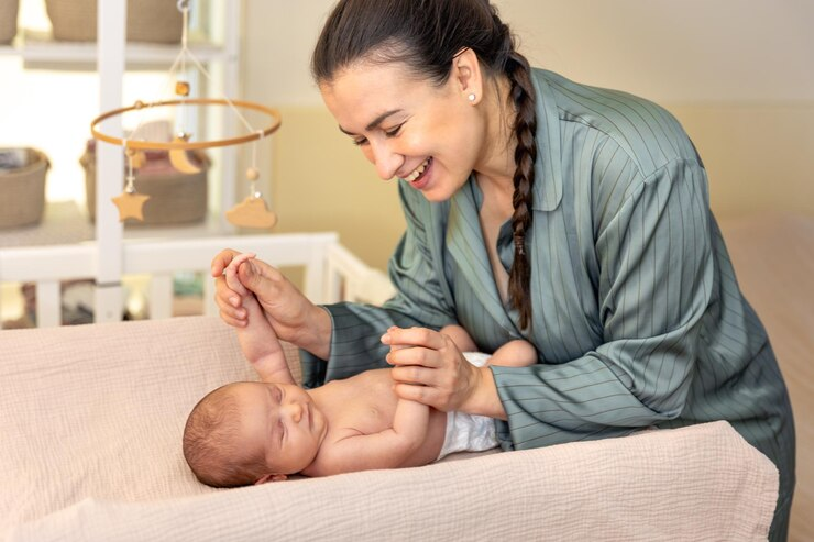 Mother with a newborn baby in a crib, highlighting the importance of pediatric complex care. 