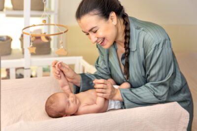 Mother with a newborn baby in a crib